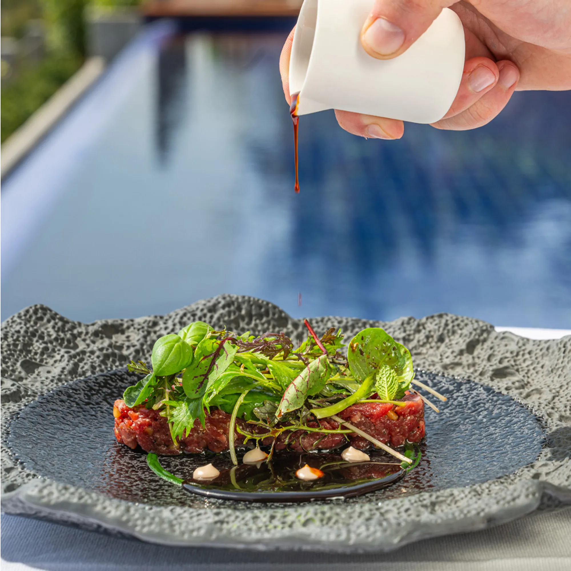 Gourmet tartare with chef finishing at the restaurant of Hotel Metropole Taormina