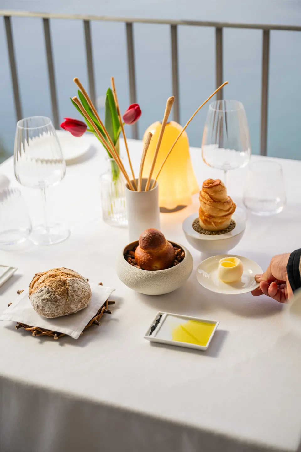 Selection of artisanal bread and Sicilian brioche with table service and sea view at the restaurant of Hotel Metropole Taormina
