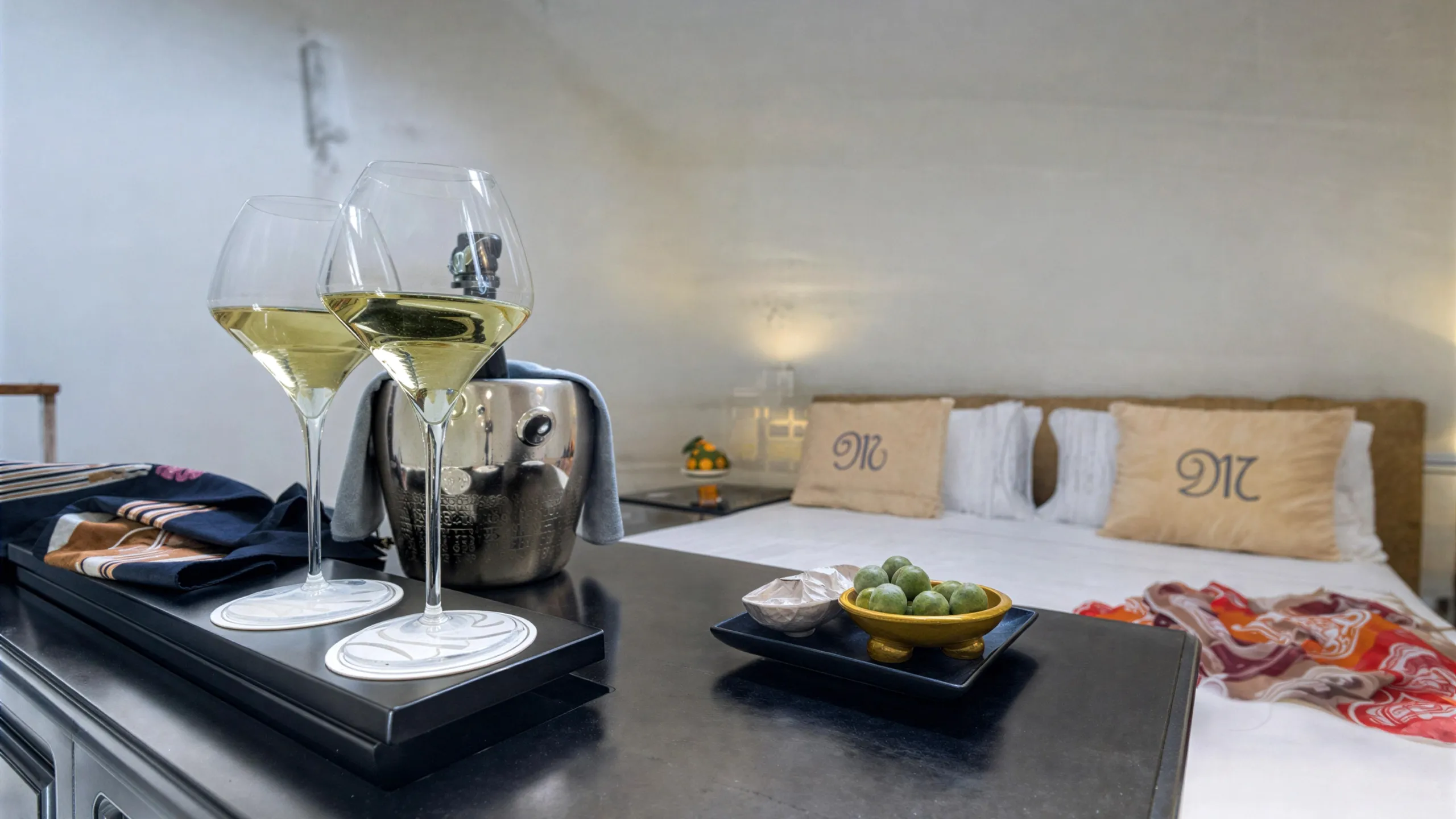 Wine glasses in the Presidential Suite at Hotel Metropole Taormina with bed in the background