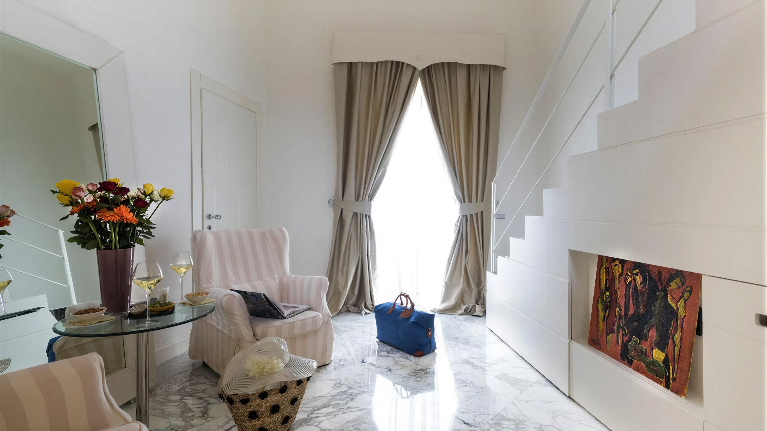 Living area of the Presidential Suite at Hotel Metropole Taormina with internal staircase and large windows