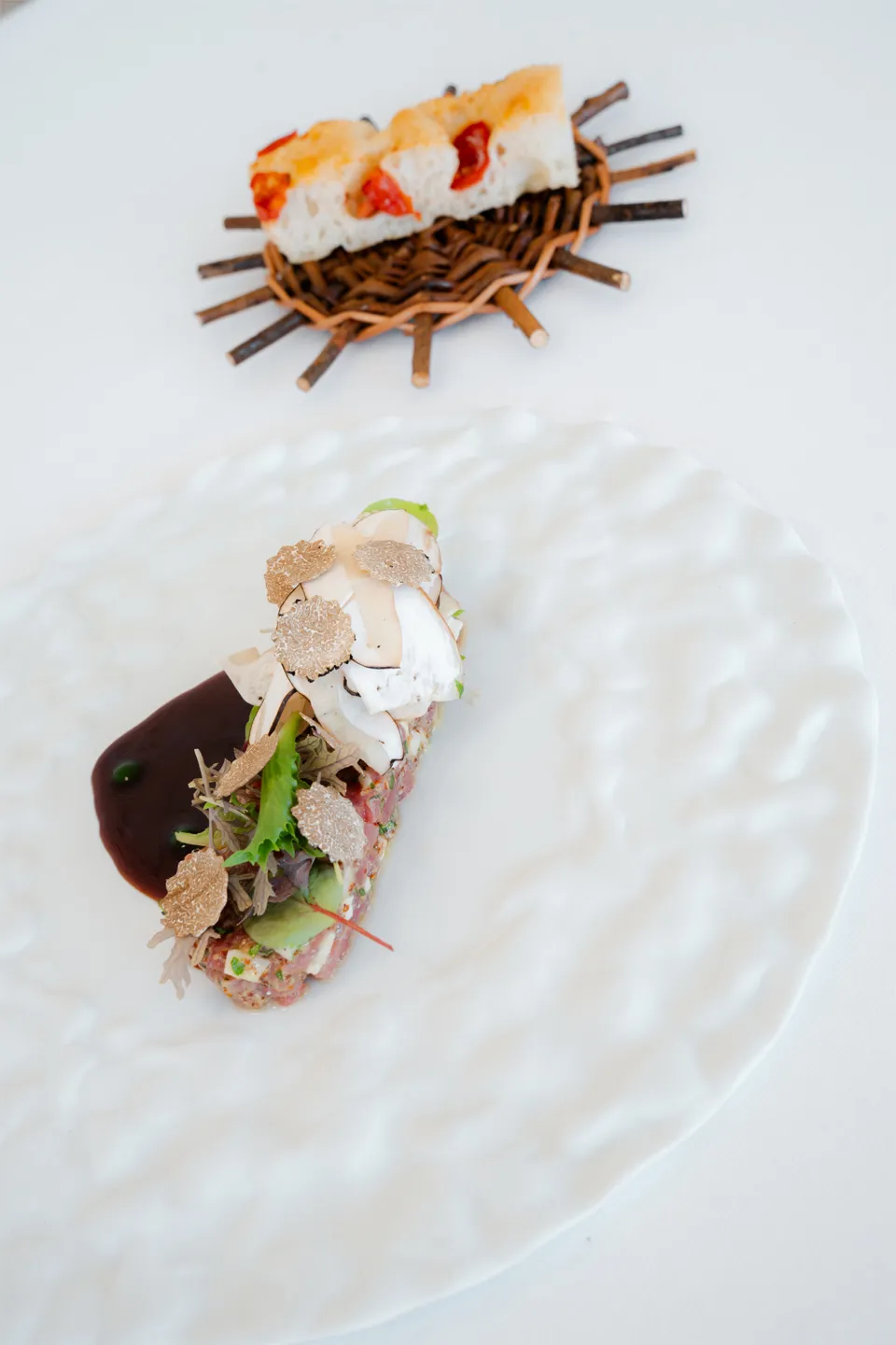 Gourmet truffle canapé with artisanal bread in the background at the restaurant of Hotel Metropole Taormina